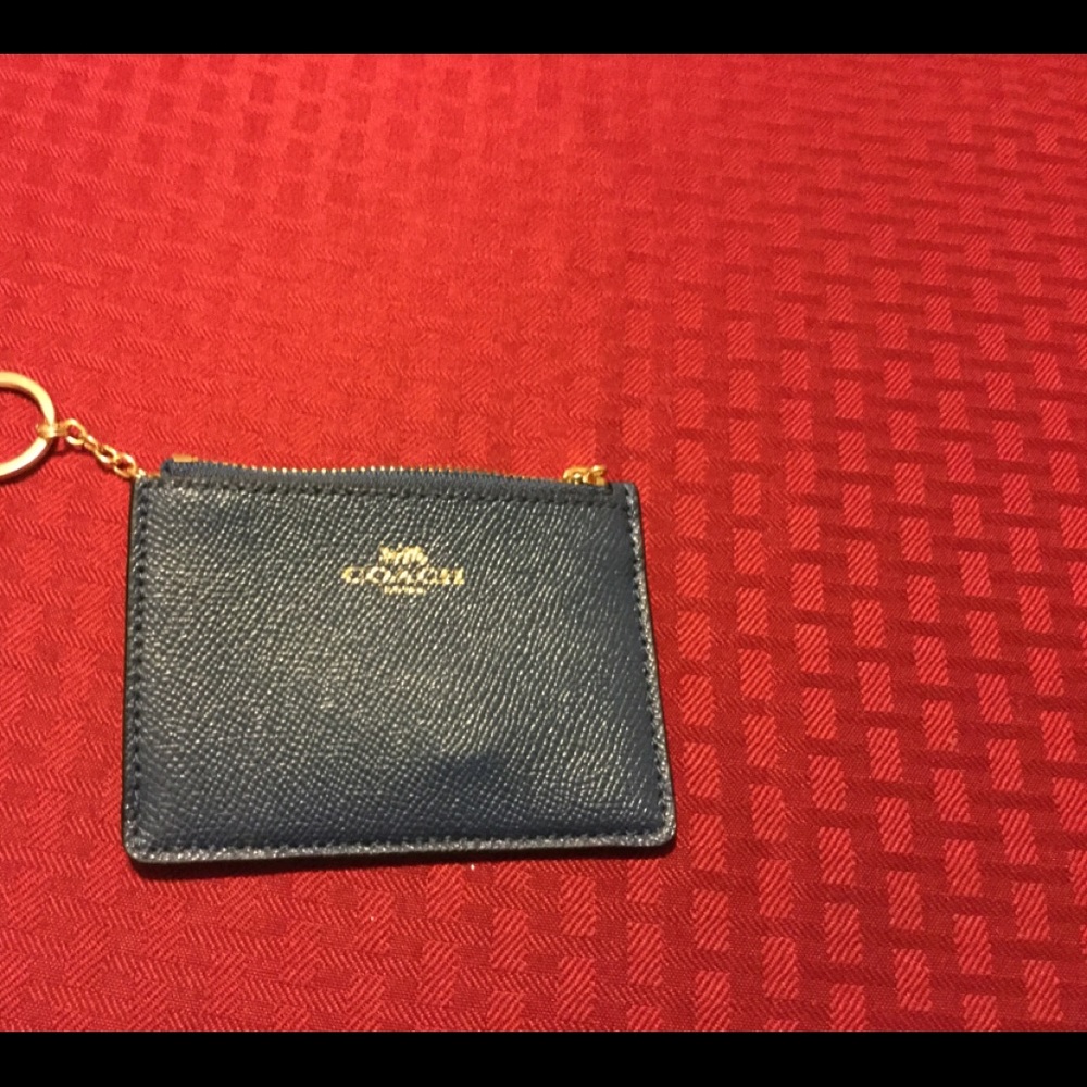 Coach ID card holder with attached key ring.